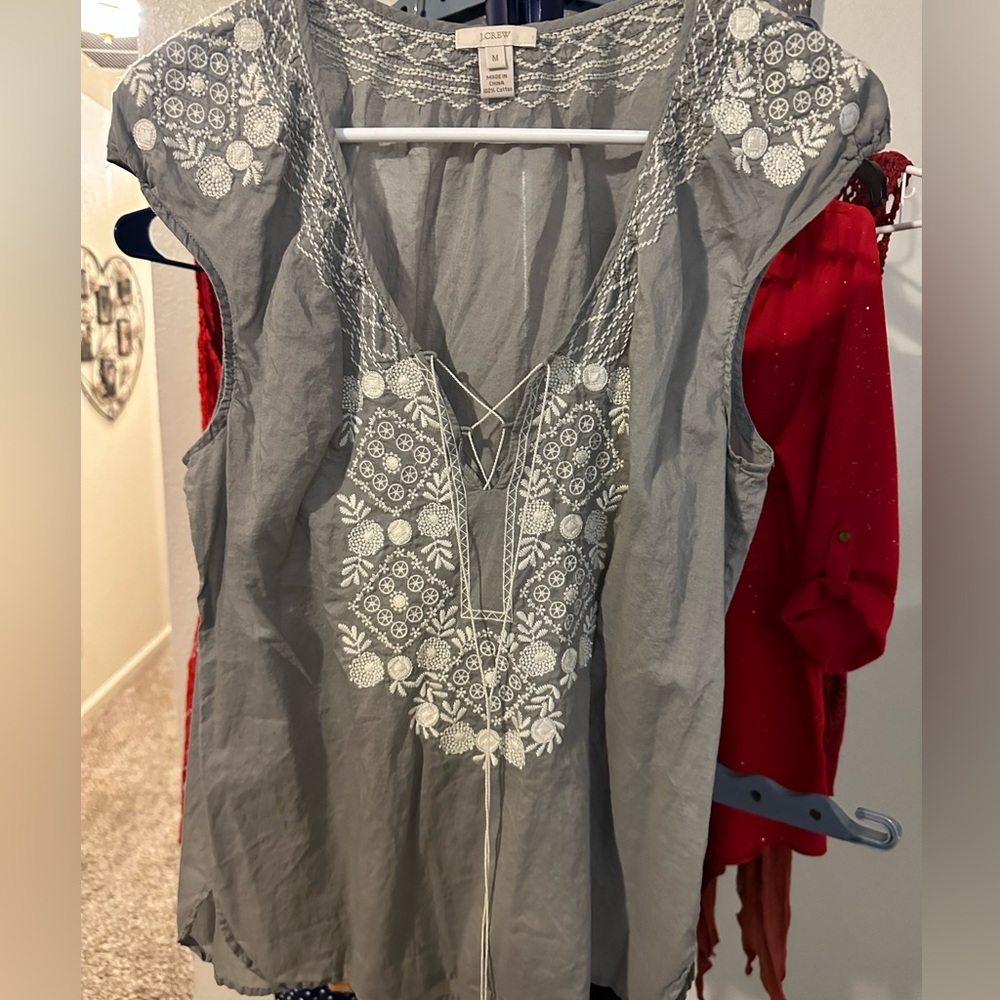 Loose fitting, hippy-style top with white embroidery.